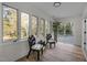 Sunroom with large windows, sliding glass doors to deck, and hardwood floors at 3014 Hope Valley Rd, Durham, NC 27707
