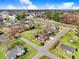 Aerial view of a property with a house, surrounded by lush greenery and a residential neighborhood at 305 E First St, Princeton, NC 27569