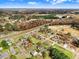 An aerial view of a neighborhood with mature trees and a mix of homes near farmland at 305 E First St, Princeton, NC 27569