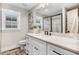 Stylish bathroom featuring a white vanity with countertop, modern fixtures, and a walk-in shower at 305 E First St, Princeton, NC 27569