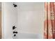 Bathroom featuring a tiled shower with a shower curtain and bronze hardware at 305 E First St, Princeton, NC 27569