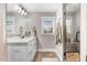 Modern bathroom features a sleek vanity, a frameless glass shower, and neutral finishes at 305 E First St, Princeton, NC 27569