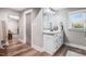 Bathroom featuring a single sink vanity with storage, framed mirror, and stylish lighting at 305 E First St, Princeton, NC 27569