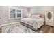 Inviting bedroom with a upholstered headboard bed, wood floors, and a large window for ample natural light at 305 E First St, Princeton, NC 27569