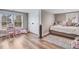 Bright bedroom with two windows, wood floors, and a closet at 305 E First St, Princeton, NC 27569