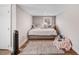 Cozy bedroom featuring a bed with stuffed animals, a window, and a rug on wood floors at 305 E First St, Princeton, NC 27569