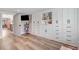 Large bonus room featuring custom built-in storage and shelving, with hardwood floors and a doorway at 305 E First St, Princeton, NC 27569