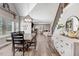 Dining area with a large wooden table, adjacent staircase, and a view into the living room at 305 E First St, Princeton, NC 27569