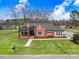 Charming brick home featuring a covered porch, manicured lawn, and classic architectural details at 305 E First St, Princeton, NC 27569