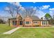 Beautiful brick home with a welcoming front porch, well-kept lawn, and a traditional design at 305 E First St, Princeton, NC 27569
