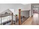 Spacious hallway with hardwood floors, a black railing, and staircase with abundant natural light at 305 E First St, Princeton, NC 27569