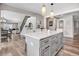 Open kitchen featuring a large center island with white countertop and elegant pendant lighting at 305 E First St, Princeton, NC 27569