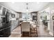 Open kitchen with long island counter, bar stools, stainless steel appliances and gray cabinetry at 305 E First St, Princeton, NC 27569