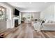 Comfortable living room with fireplace and couch featuring wood flooring and recessed lighting at 305 E First St, Princeton, NC 27569