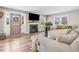 Bright living room with a fireplace, hardwood floors, and comfortable seating at 305 E First St, Princeton, NC 27569