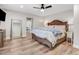 Serene main bedroom features a cozy bed, modern ceiling fan, and seamless access to ensuite bathroom at 305 E First St, Princeton, NC 27569