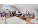 Spacious playroom area with a comfortable sofa, a decorative rug, and an abundance of toys at 305 E First St, Princeton, NC 27569