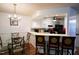 Kitchen view with breakfast bar, glass table, and wooden chairs at 3336 Tarleton W, Durham, NC 27713