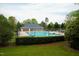 Community pool with green grass, trees and a clubhouse at 3336 Tarleton W, Durham, NC 27713