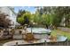 View of the backyard with a wooden deck and above-ground pool surrounded by a lush green lawn and mature trees at 402 Green Turret Dr, Rolesville, NC 27571