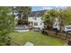 A spacious backyard features a well-maintained lawn, patio furniture, and a partially covered above ground pool at 402 Green Turret Dr, Rolesville, NC 27571
