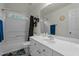 Bathroom with a white vanity, large mirror, and a shower-tub combination with a curtain at 402 Green Turret Dr, Rolesville, NC 27571