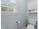 Cozy bathroom features a toilet, window, and built in shelving at 402 Green Turret Dr, Rolesville, NC 27571