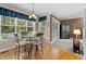Bright dining area with a round table, hardwood floors, and a view of the pool at 402 Green Turret Dr, Rolesville, NC 27571