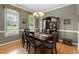 Dining room with hardwood floors, chandelier lighting, and large china cabinet at 402 Green Turret Dr, Rolesville, NC 27571