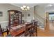 Open dining room with hardwood floors leading to a carpeted staircase at 402 Green Turret Dr, Rolesville, NC 27571