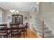 Dining room with hardwood floors and carpeted stairs with white railings at 402 Green Turret Dr, Rolesville, NC 27571