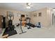 Dedicated home gym area with multiple workout machines, wall art, and carpeted floors at 402 Green Turret Dr, Rolesville, NC 27571