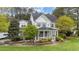 Attractive home with a covered front porch, surrounded by mature trees and vibrant landscaping at 402 Green Turret Dr, Rolesville, NC 27571