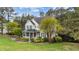 Beautifully landscaped two-story home with lush greenery surrounding the property at 402 Green Turret Dr, Rolesville, NC 27571
