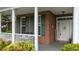 Cozy front porch with brick accents, white columns, and inviting decor at 402 Green Turret Dr, Rolesville, NC 27571