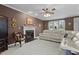 Cozy living room featuring a fireplace and a comfortable white leather sofa at 402 Green Turret Dr, Rolesville, NC 27571