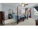 Bright main bedroom featuring a cozy four-poster bed and ample natural light at 402 Green Turret Dr, Rolesville, NC 27571
