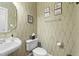 Elegant half bathroom with patterned wallpaper and a pedestal sink at 402 Green Turret Dr, Rolesville, NC 27571