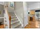 Carpeted staircase with wood railing leading to the upper level at 402 Green Turret Dr, Rolesville, NC 27571