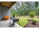 Backyard patio with green space perfect for outdoor entertaining, featuring seating and a grill at 4504 Mint Leaf Ln, Raleigh, NC 27612