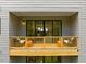 Spacious balcony with wooden railings and outdoor seating offering views of the surrounding greenery at 4504 Mint Leaf Ln, Raleigh, NC 27612