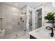 Modern bathroom features a glass-enclosed shower, sleek fixtures, and neutral tile at 4504 Mint Leaf Ln, Raleigh, NC 27612