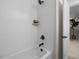 Bright bathroom showing a white tub and shower combination with black fixtures at 4504 Mint Leaf Ln, Raleigh, NC 27612