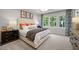 Bright bedroom with large windows, tray ceiling, and stylish decor with neutral colors at 4504 Mint Leaf Ln, Raleigh, NC 27612