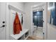 Well-organized entryway with a coat rack, bench, storage baskets, and a view into the stylish bathroom at 4504 Mint Leaf Ln, Raleigh, NC 27612