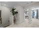 Bright hallway with a potted plant, leading to a bedroom and an office space at 4504 Mint Leaf Ln, Raleigh, NC 27612
