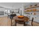 Bright, open kitchen featuring white cabinets, stainless steel appliances, a large island, and a dining table at 4504 Mint Leaf Ln, Raleigh, NC 27612