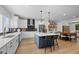 Bright, open kitchen with white cabinets, stainless steel appliances, and a large island with bar seating at 4504 Mint Leaf Ln, Raleigh, NC 27612