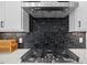 Close up on a kitchen featuring a stainless steel range, vent hood and eye-catching backsplash at 4504 Mint Leaf Ln, Raleigh, NC 27612