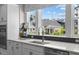 Well-lit kitchen with sink, quartz countertop and modern faucet, with view of other homes at 4504 Mint Leaf Ln, Raleigh, NC 27612